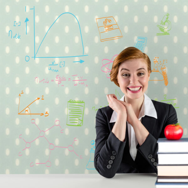 Excited Redhead Teacher Sitting Desk Against Red Apple Pile Books