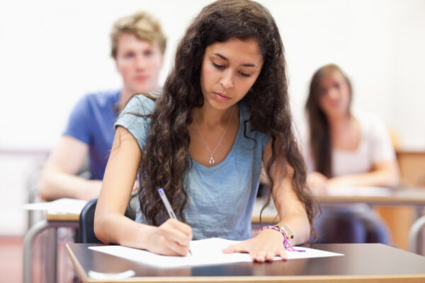 Students Taking Notes While Their Classmates Are Listening